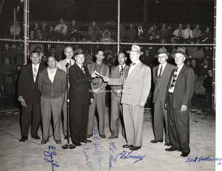 Ernie Ziegler and a host of dignitaries at Waddell Park on the baseball diamond.