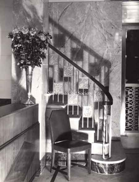 Photograph of the interior staircase leading up to the balcony from the main lobby of the Niles Trust Company on opening day. 