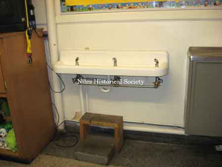 Drinking fountain with steps in cafeteria