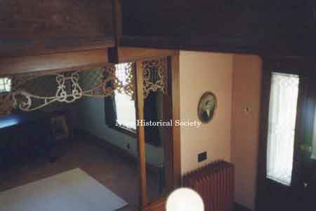 View of the fretwork and oak column spanning the entrance between the foyer and living room.