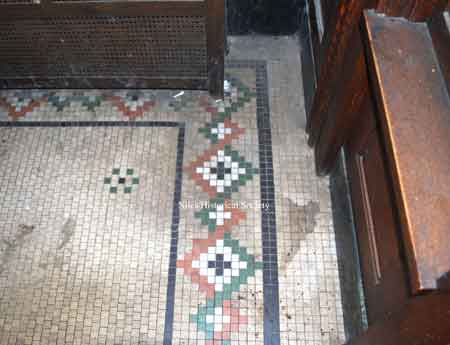 Mosaic tile floor inside front entrance.