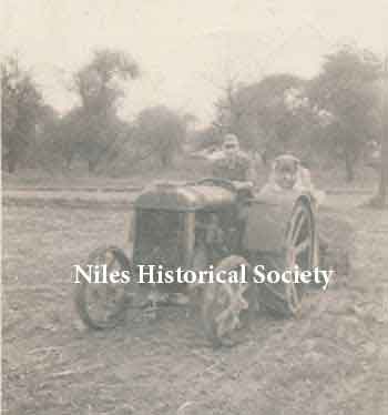 Phyllis' dad on the same tractor with his dog, Shep. 