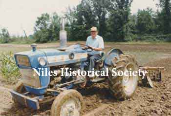 Phyllis' dad on tractor, 'Big Blue', after retirement from the farm market.