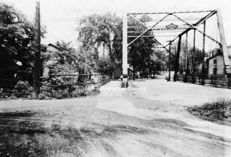 In 1904 a new bridge was constructed over Mosquito Creek on Robbins Ave. The old bridge, the one pictured here was moved to E. Federal St. In 1950 a new span replaced the old bridge.