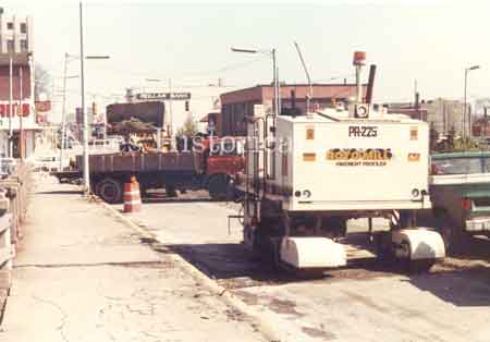 Picture taken during the 1981 renovation of the Main Street Viaduct. The name on the truck is Bridge Specialists of Youngstown, Ohio. The crew removed the 1933 paving bricks and poured new concrete.