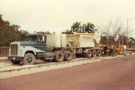 Picture taken during the 1981 renovation of the Main Street Viaduct. The name on the truck is Bridge Specialists of Youngstown, Ohio. The crew removed the 1933 paving bricks and poured new concrete.