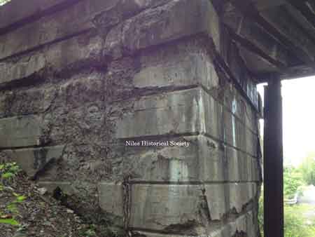 The steel girder railroad bridge that overpasses the roadway.