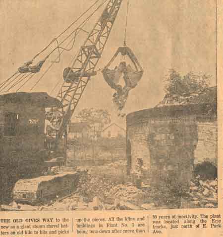 The old gives way to the new as a giant steam shovel batters an old kiln to bits and picks up the pieces.