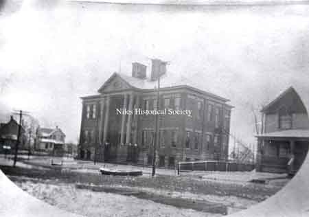 Third Street School, now Garfield School, with a rowboat floating in the street.