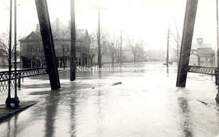 Postcard view of the 1913 flood that created havoc up and down the state. Taken from the Main Street bridge over the Mahoning River facing south. The building at the upper right is the Eagles Lodge building. 