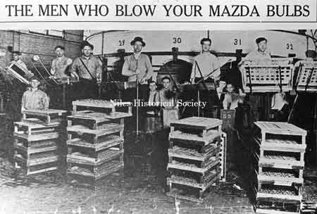 Photo of a newspaper article captioned "The men who blow your Mazda bulbs".