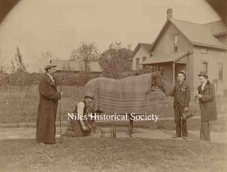 The man wearing the long coat, and holding the fishing pole, is my Great-Grandfather