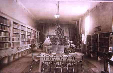 The interior of the Niles Library when it was in a rent free room owned by W. A. Thomas on the bend of Furnace Street (East State Street).