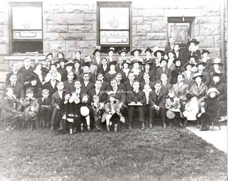 The 1915-16 Methodist Church picnic. Ernst T. Law is holding his daughter Venita Law Heinmiller. His wife, Hazel Hanson Law, is the lady in the third row on the right side in a hat with white trim.