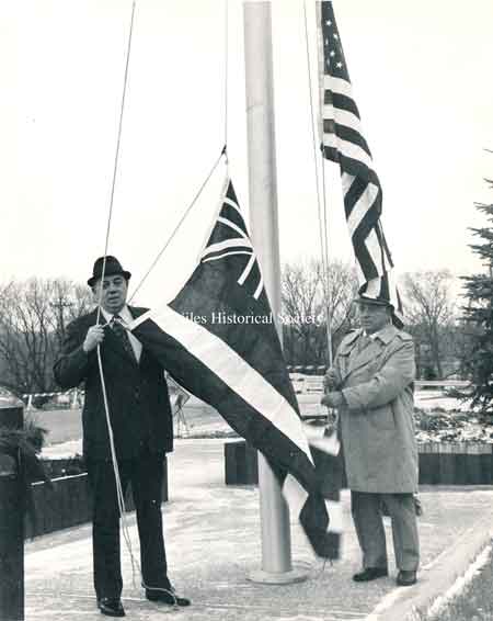 John Scott and Police Chief Ross raising the flag at the new Safety-Services Complex on East State Street.