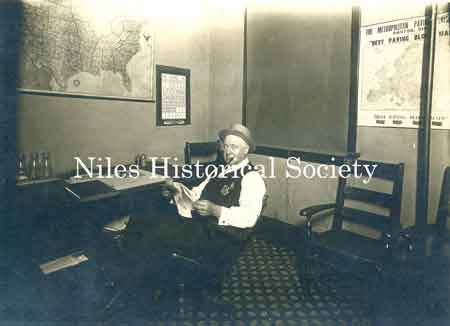 1915 photo taken of Howard Ohl, Sanitary Police, in his city building office.