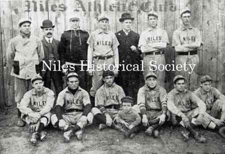 Members of the Niles Athletic Club. Seated: Davy Smith. Standing: unknown, Bill Pritchards, unknown, Police Chief Nicholas, Billy Thomas, unknown, unknown. Mascot: Jacky Phillips.