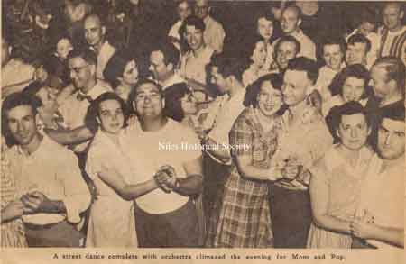 A street dance, with music climaxed the evening for Mom and Pop. Ray Sanfrey is in the front row with white t-shirt.