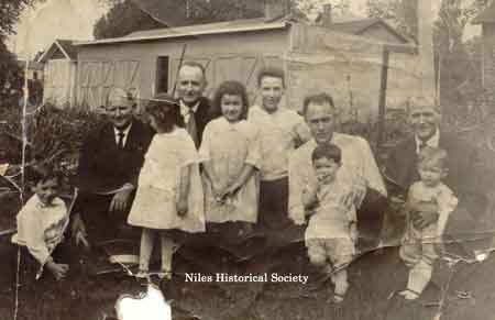 Adult Men l-r: John Nicholas (1877-1953), Arthur Nicholas (1881-1960), Samuel Nicholas (1888-1965), William Nicholas (1879-1926), child o left is William Martin Nicholas (1913-1984), child on far right is Robert Nicholas (1918-1944).