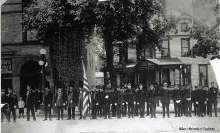 The Knights of Pythias members standing in front of the Wagstaff building which stood north of the Swaney building on the west side of North Main Street where the McKinley Memorial grounds now stand.