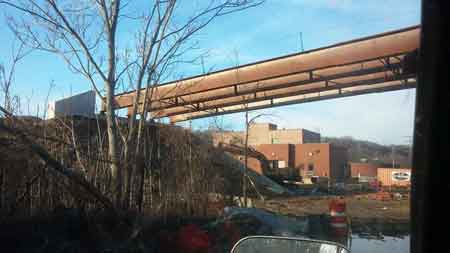 The final photos show the demolition in October 2014 and the new steel beams being placed in March 2015.