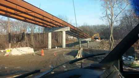 The final photos show the demolition in October 2014 and the new steel beams being placed in March 2015.