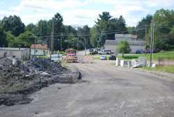 The final photos show the demolition in October 2014 and the new steel beams being placed in March 2015.