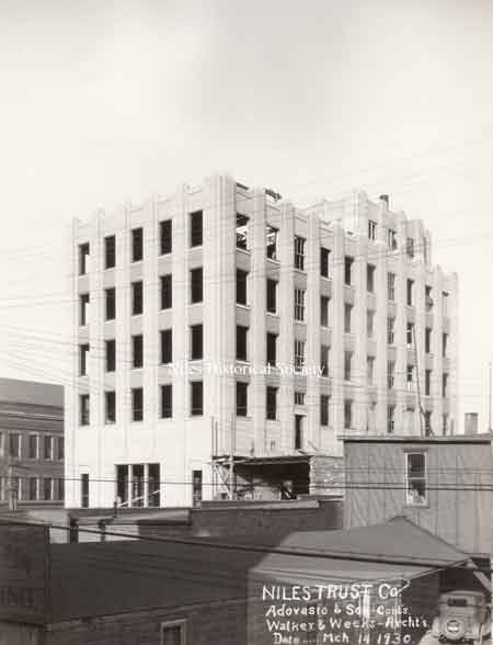 A series of photographs documenting the various stages of the construction of the Niles Trust Company Building.