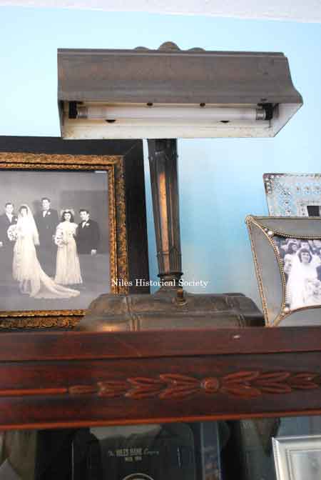 Detail of wooden cabinet and lamp.