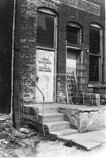 Photo of the rear entrance of the Ideal Dept. Store, located on Main Street, east side.