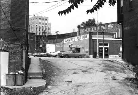 Photo taken of the AMVETS Post 106 located at 76 East State Street looking through Race Alley, a narrow path from the Mosquito Creek dam to the grist mill built in 1806-1807 by James Heaton.